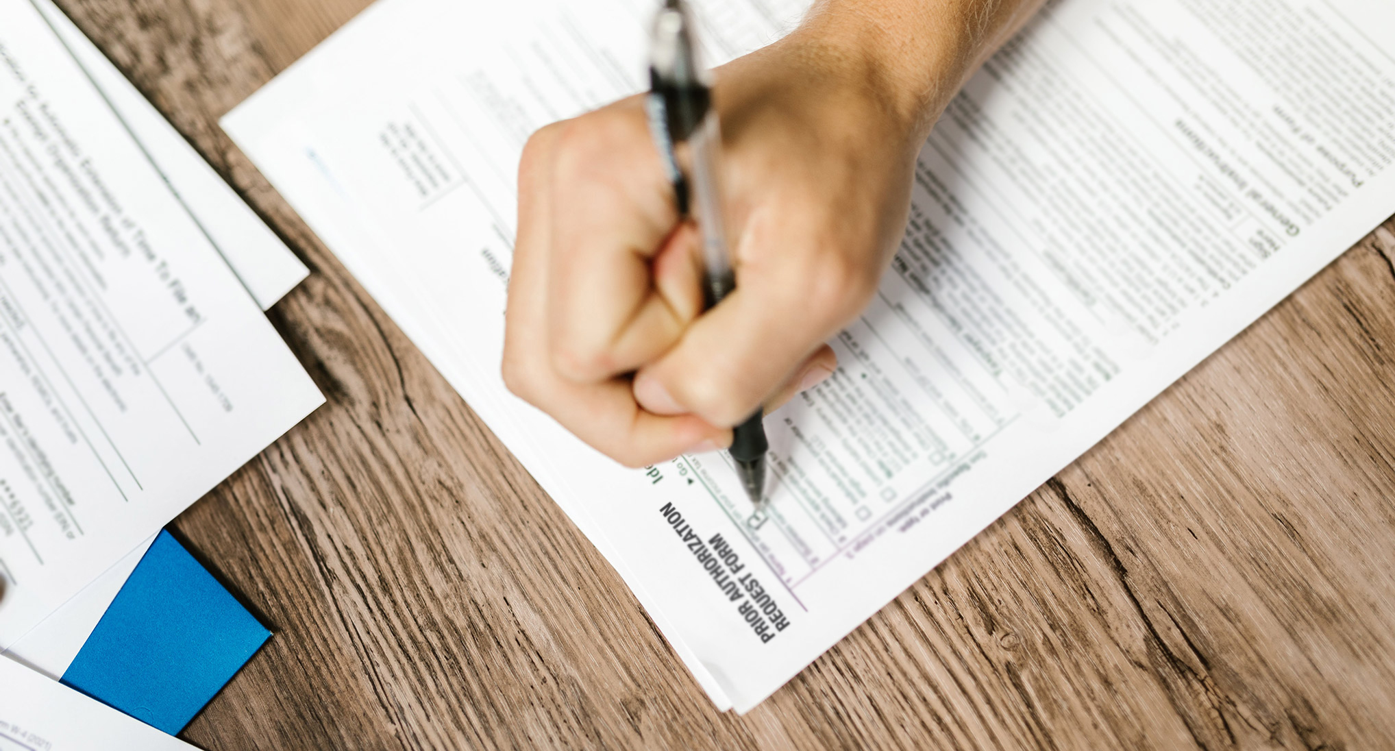 Person filling out medical paperwork.